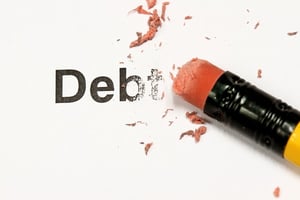 A pencil eraser erasing the word "Debt" from a piece of paper, representing the need for bankruptcy help in Rochester, MN.