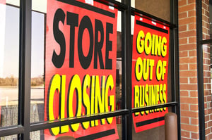 A storefront with two red signs in the window that say "Store Closing" and "Going Out of Business", posing the question, Should I close my failing business before of after filing bankruptcy?