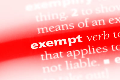 Closeup of the word exempt on dictionary page, where the background is a vibrant red and the words are white, symbolizing understanding Minnesota law to protect your property.