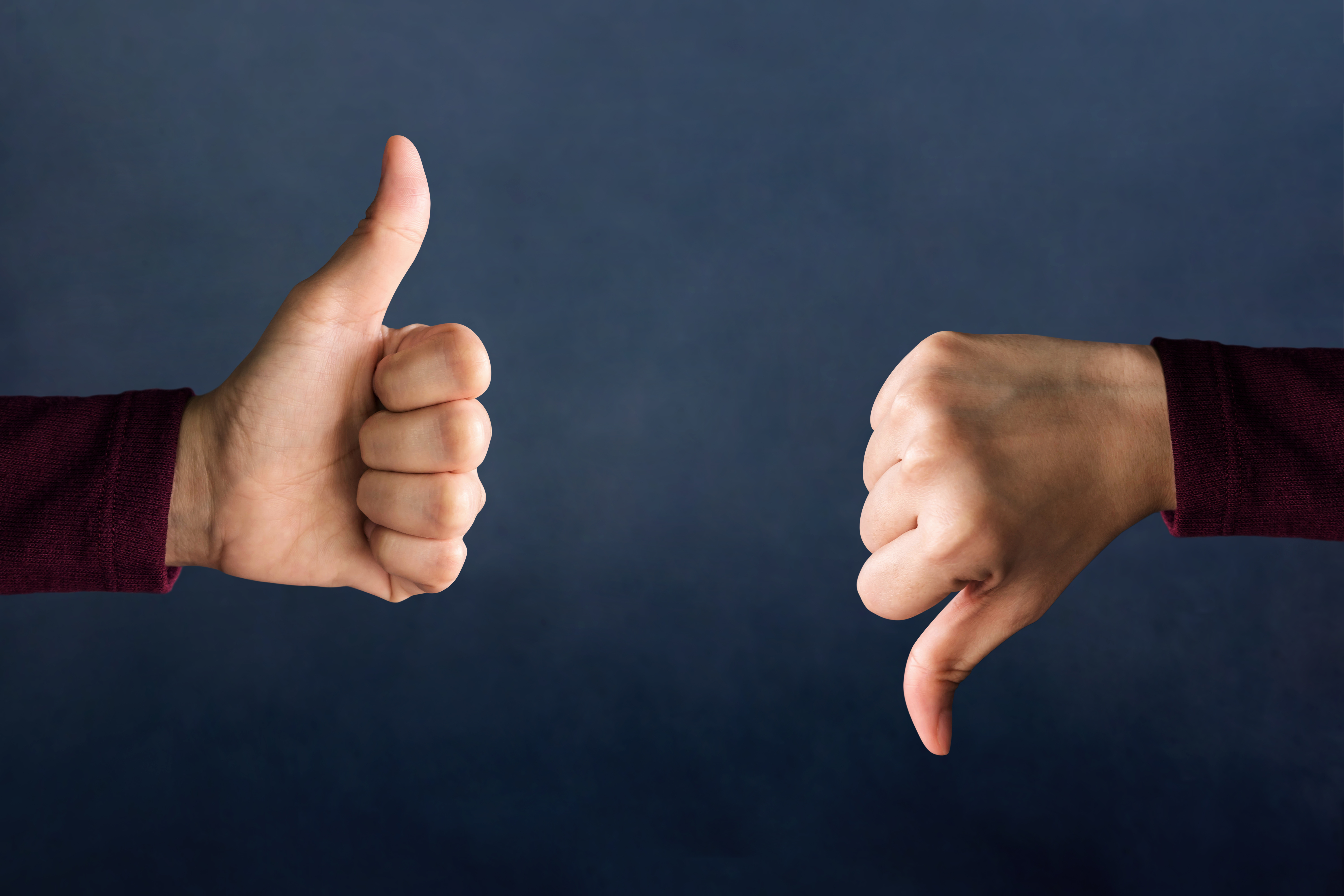 Two hands on either side of the photo, the one on the left shows a thumbs up and the one on the right shows a thumbs down, representing options available after the bankruptcy means test.