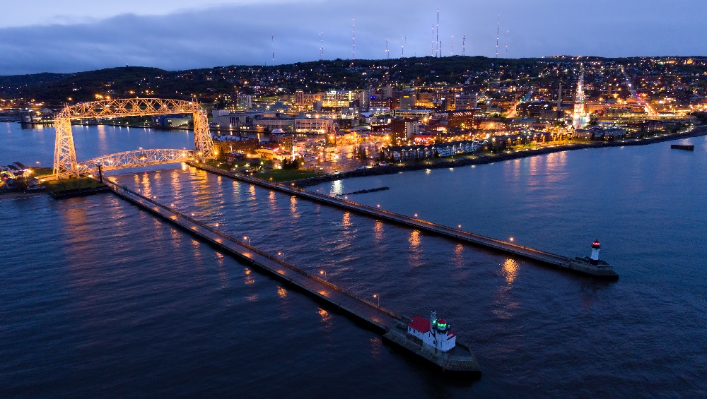 A lit maritime structure at night on the lake, representing the need for a bankruptcy attorney near me in Duluth, MN