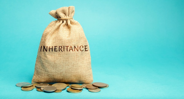A burlap sack with the word INHERITANCE written on it in dark brown, sitting on top of some gold coins and against a blue-green background, representing understanding Minnesota law to protect your property.